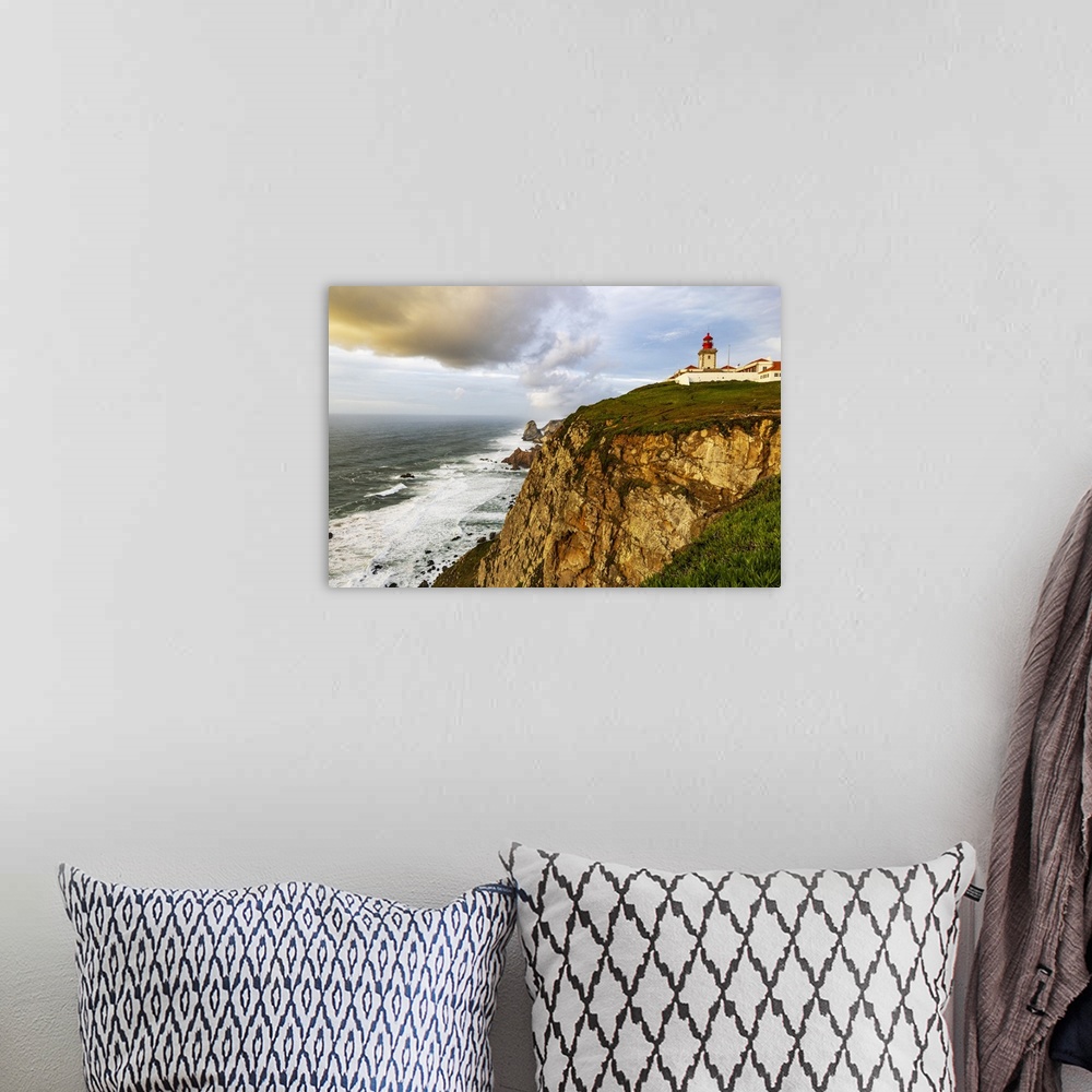 A bohemian room featuring Cabo do Roca Lighthouse at last light in Colares, Portugal.
