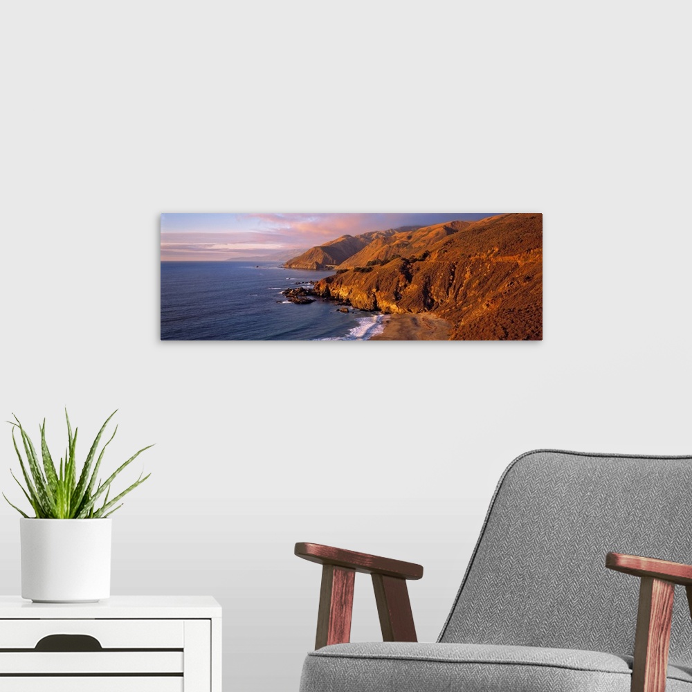 A modern room featuring USA, California, Big Sur. Sunset casts a golden hue over the Coast Range near Big Sur, on Highway...