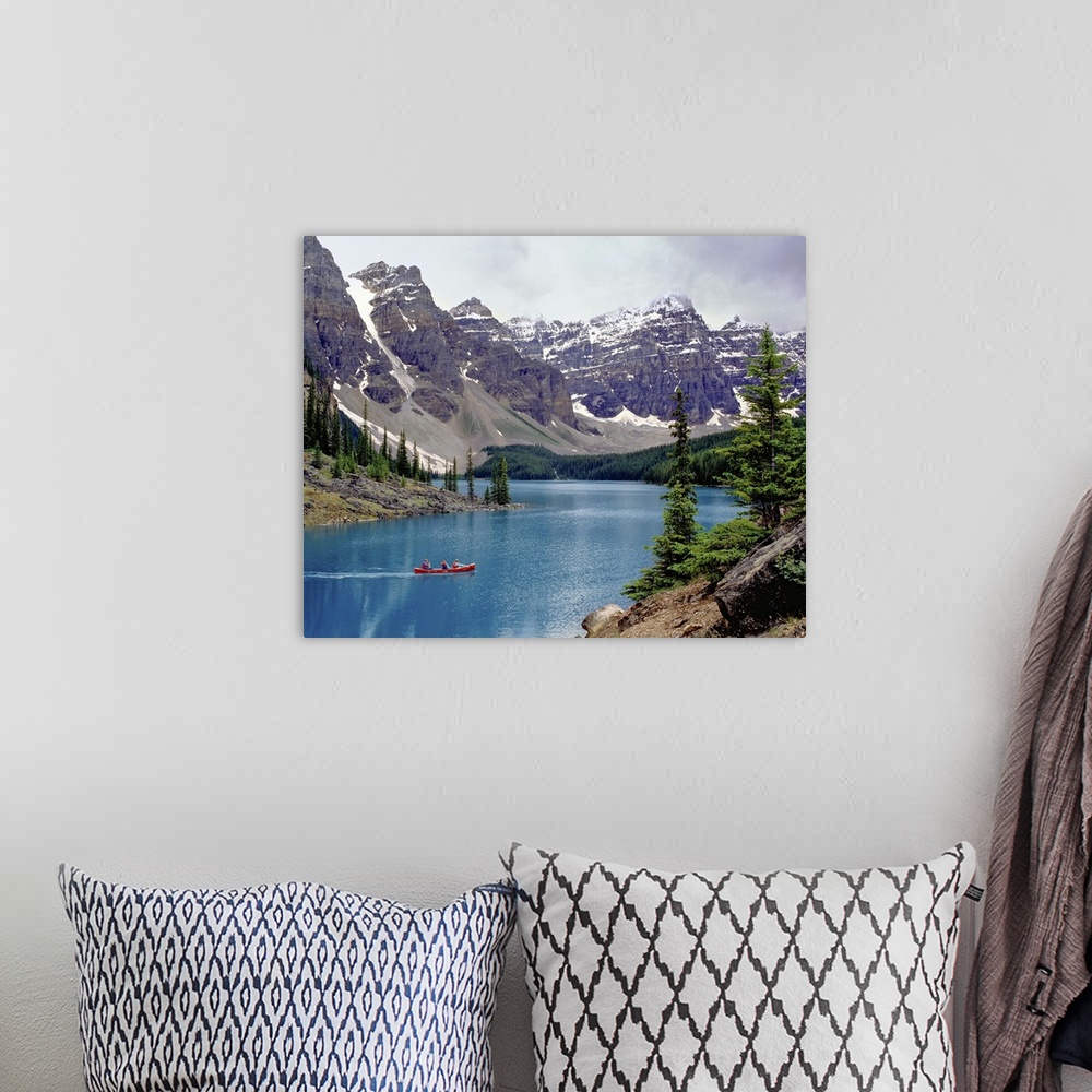 A bohemian room featuring Canada, Alberta, Moraine Lake. A canoe glides across beautiful Moraine Lake in the Valley of the ...