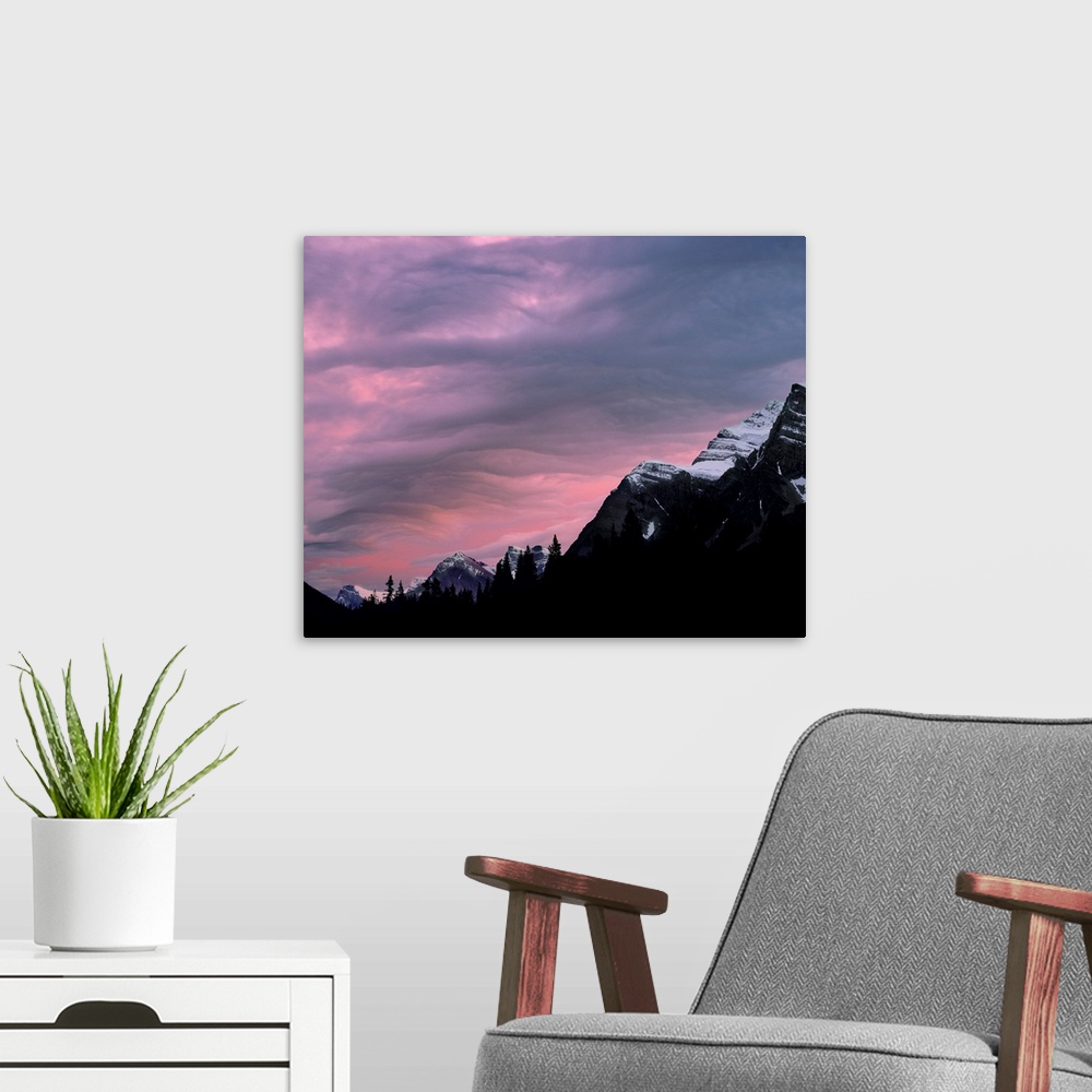 A modern room featuring Canada, Alberta, Rocky Mountains. The setting sun colors the clouds above the Canadian Rockies, A...