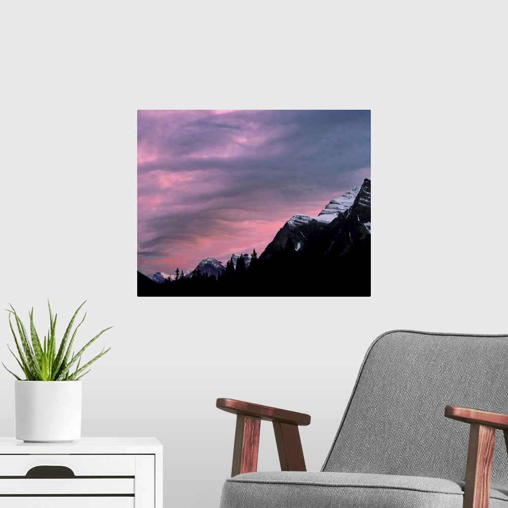 A modern room featuring Canada, Alberta, Rocky Mountains. The setting sun colors the clouds above the Canadian Rockies, A...
