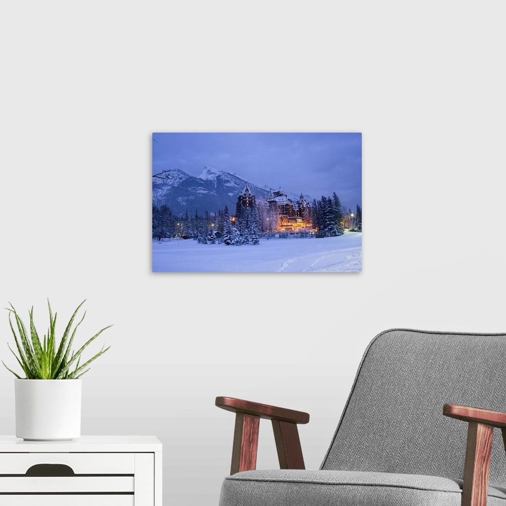 A modern room featuring Banff Springs Hotel in snowy evening light.  Banff, Canada