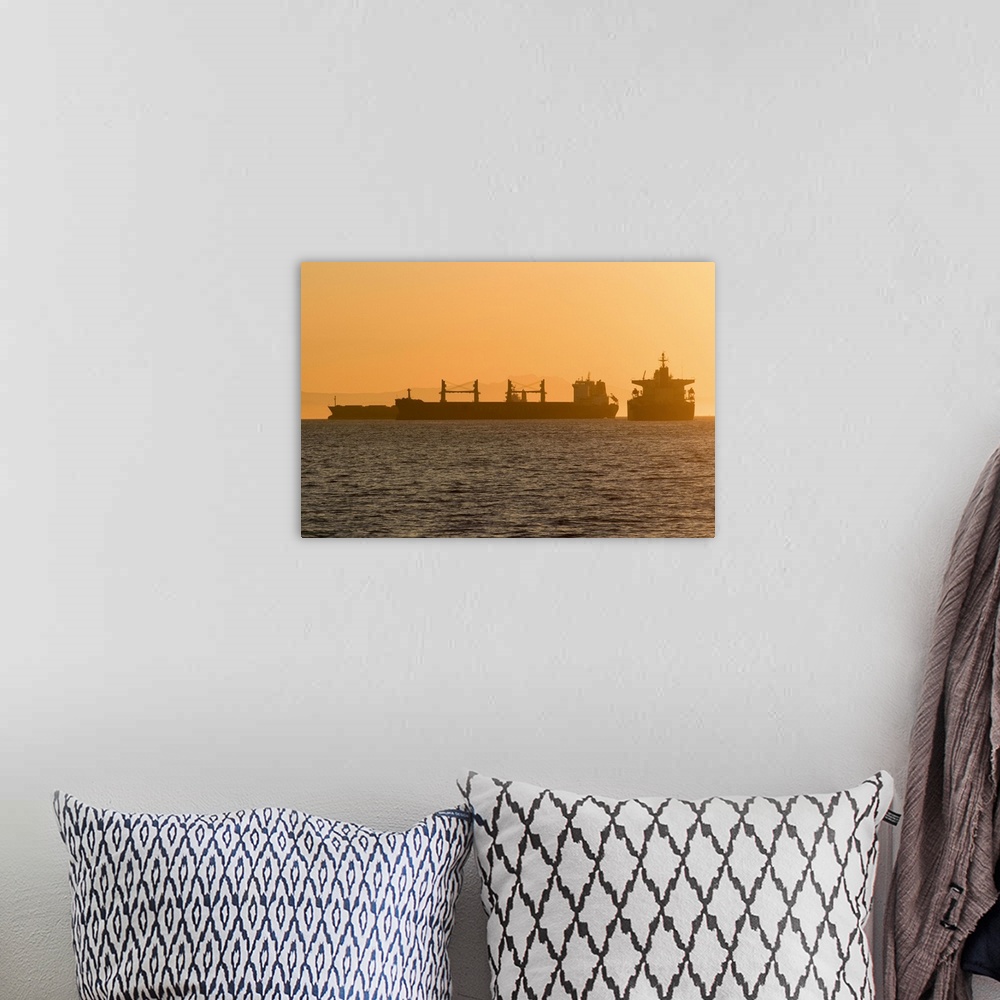 A bohemian room featuring Cargo ships waiting at anchor in English Bay Beach in the West End of Vancouver, BC, Canada.