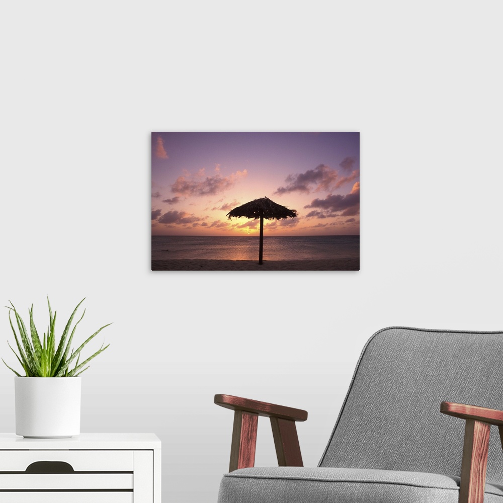 A modern room featuring Aruba. Dutch Caribbean. Eagle beach at sunset.