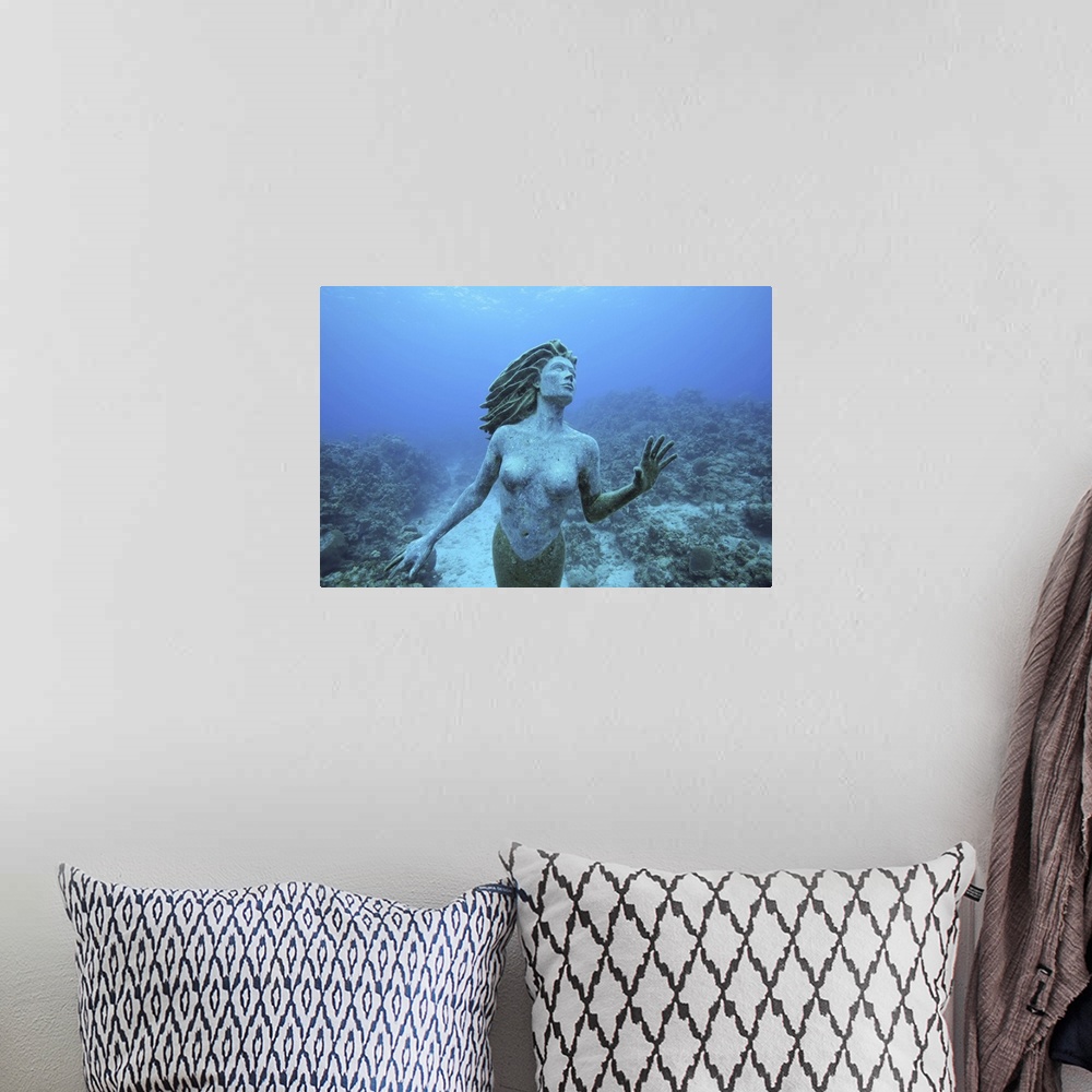 A bohemian room featuring Cayman Islands, Grand Cayman Island, Underwater view mermaid sculpture in shallow coral reefs in ...