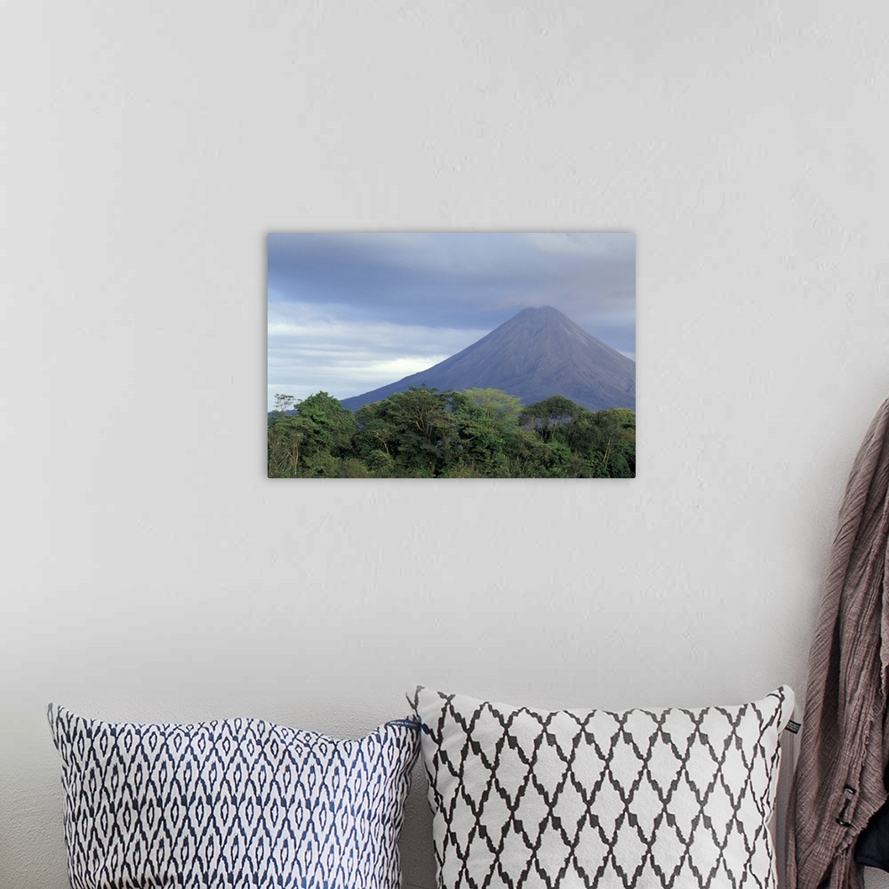 A bohemian room featuring Central America, Costa Rica, Arenal Volcano. Rainforest beneath Arenal (erupting since 1968).