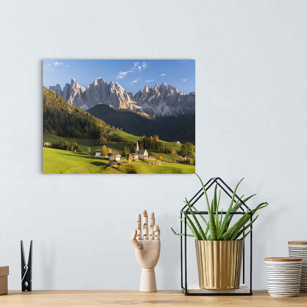 A bohemian room featuring Church Sankt Magdalena in Villnoess valley in autumn, Geisler Mountains. Italy, South Tyrol.