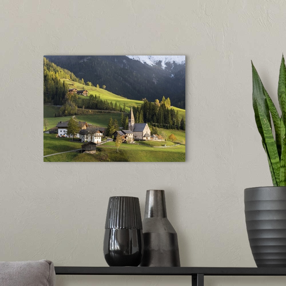 A modern room featuring Church Sankt Magdalena in Villnoess valley in autumn, Geisler Mountains. Italy, South Tyrol.