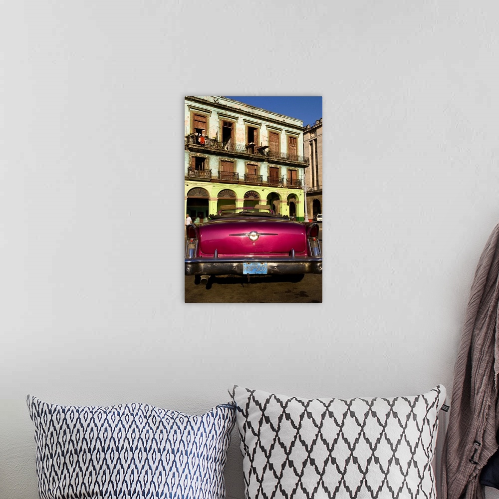 A bohemian room featuring Classic 50s Buick colorful convertible auto in Havana Cuba Habana in front of old worn and colorf...