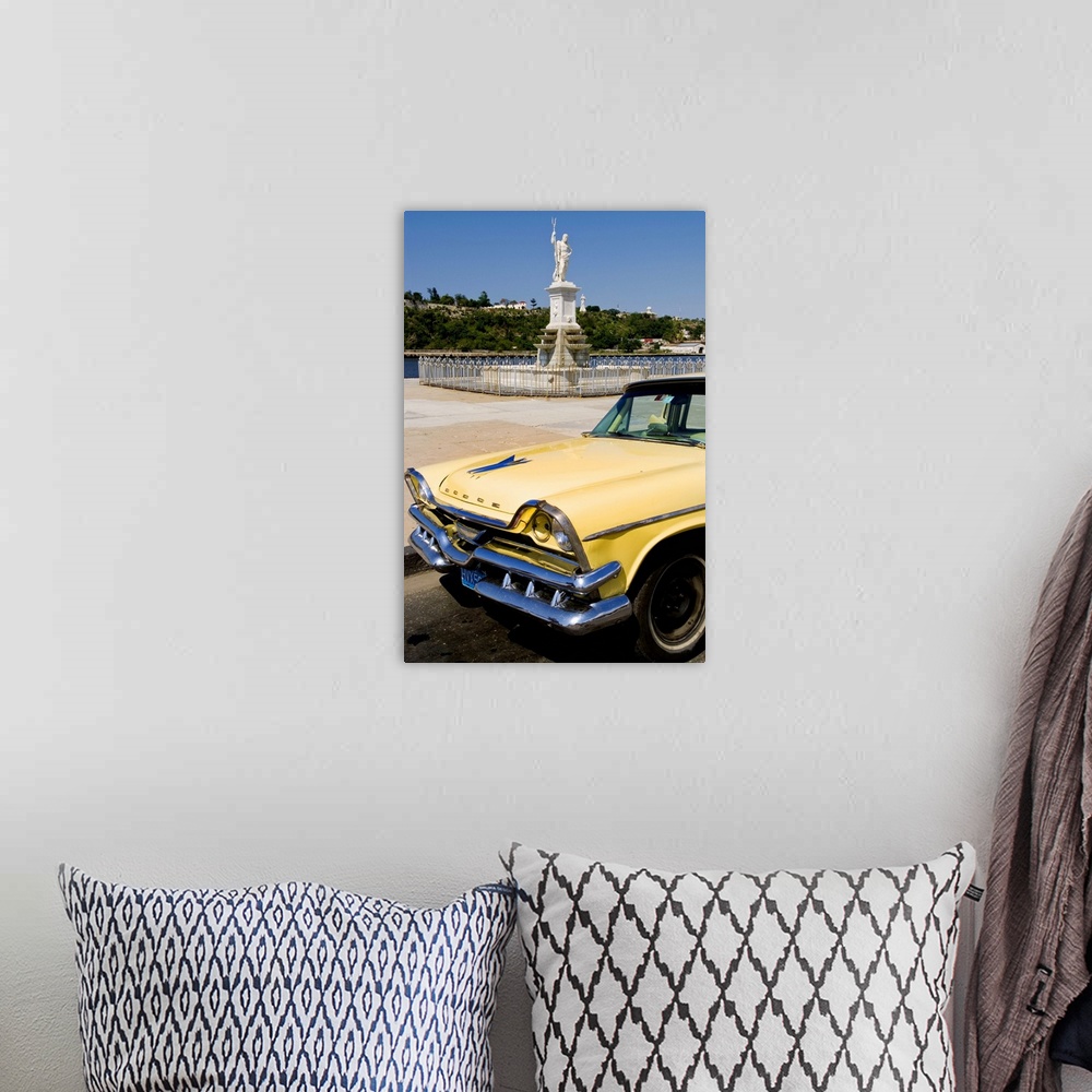 A bohemian room featuring Classic Dodge 50s auto in front of river and statues with Christ statue on hill in background in ...