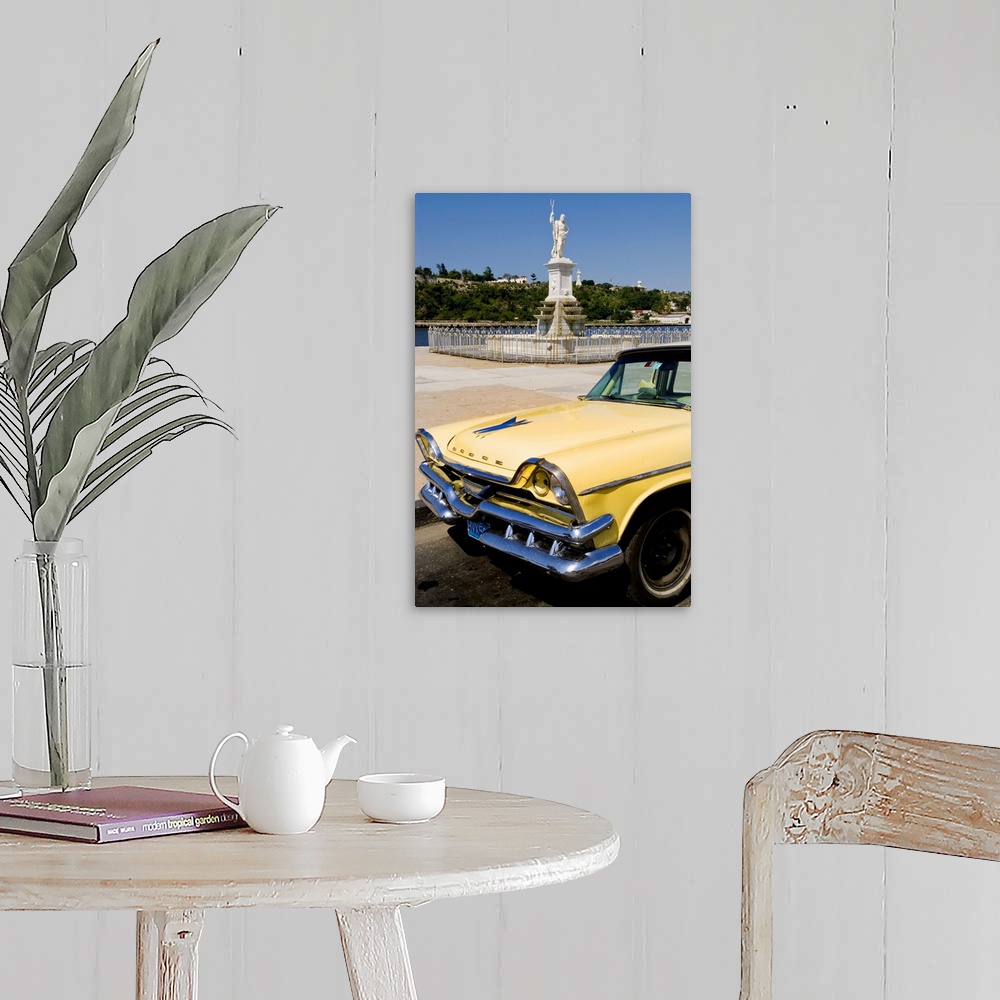 A farmhouse room featuring Classic Dodge 50s auto in front of river and statues with Christ statue on hill in background in ...