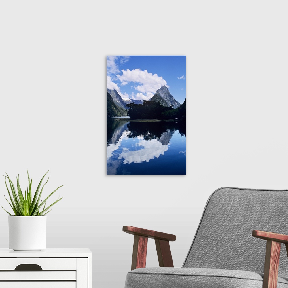 A modern room featuring Cloud-capped Mitre Peak rises out of Milford Sound in Fiordland National Park, South Island, New ...