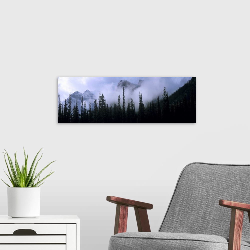 A modern room featuring Canada, Alberta, Banff NP. Clouds swirl around mountain peaks above Lake Louise Junction in Banff...
