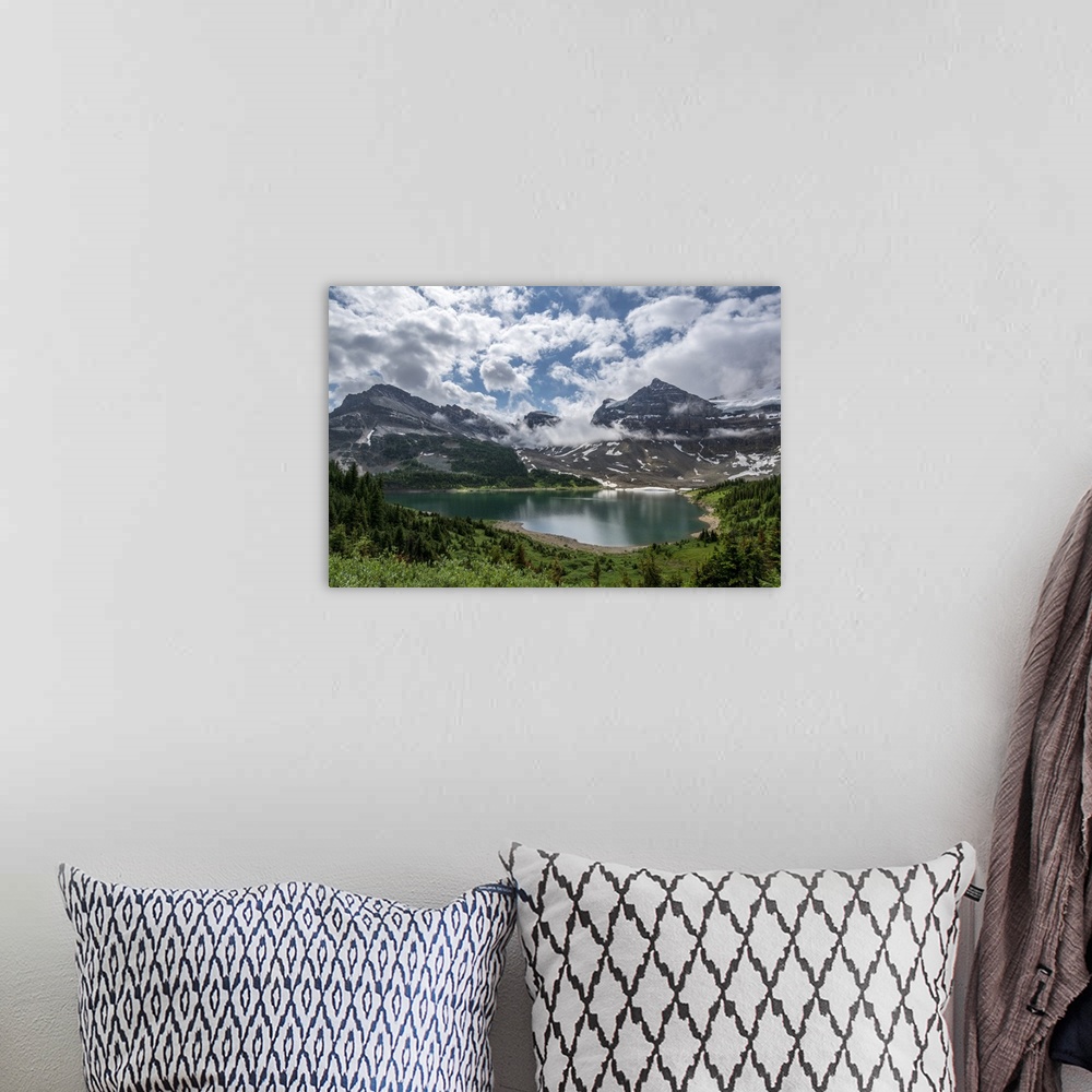 A bohemian room featuring Clouds over an alpine lake in Assiniboine Provincial Park.