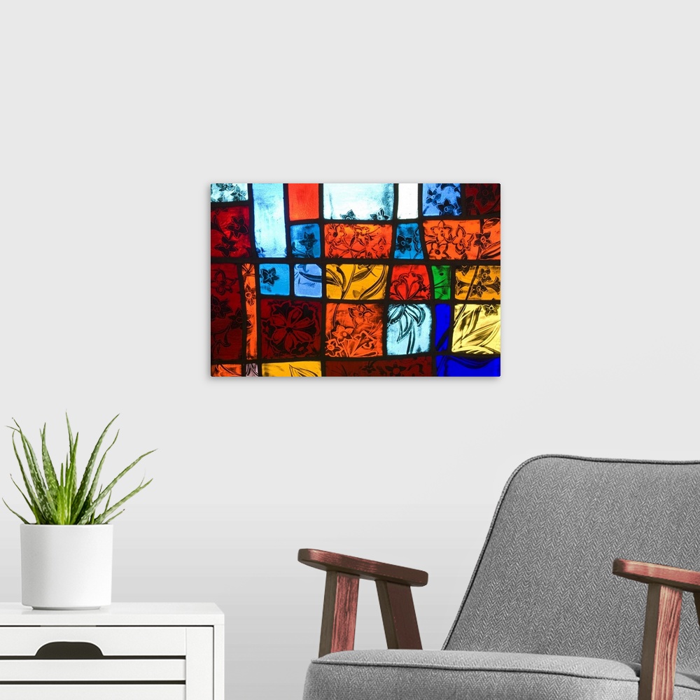 A modern room featuring Colorful stained glass at a church with nature themes.