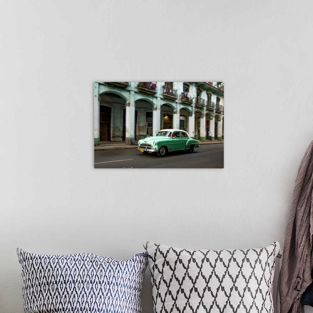 A bohemian room featuring Cuba, Havana, classic green car and arches of colonial building. .
