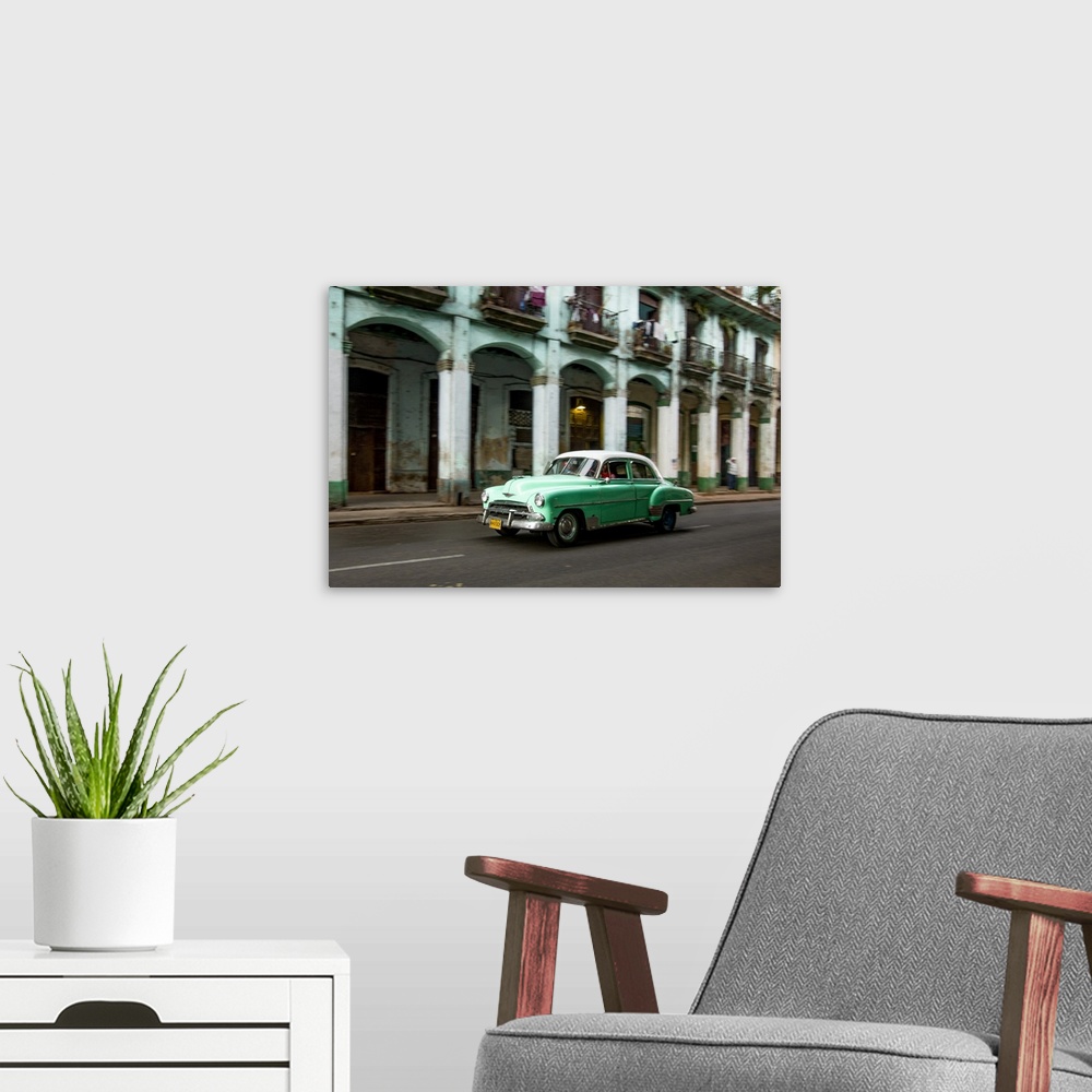 A modern room featuring Cuba, Havana, classic green car and arches of colonial building. .