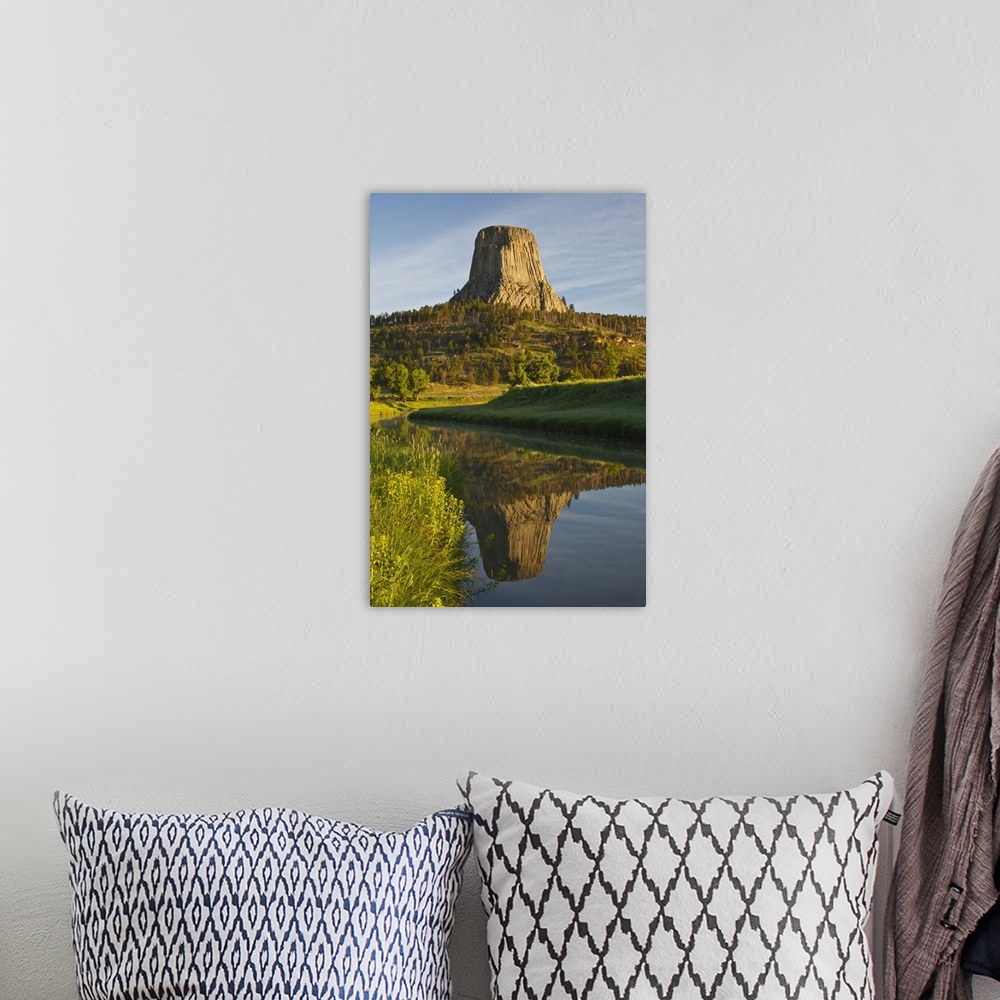 A bohemian room featuring Devil's Tower National Monument, Wyoming, reflected in Belle Fourche River at sunrise.