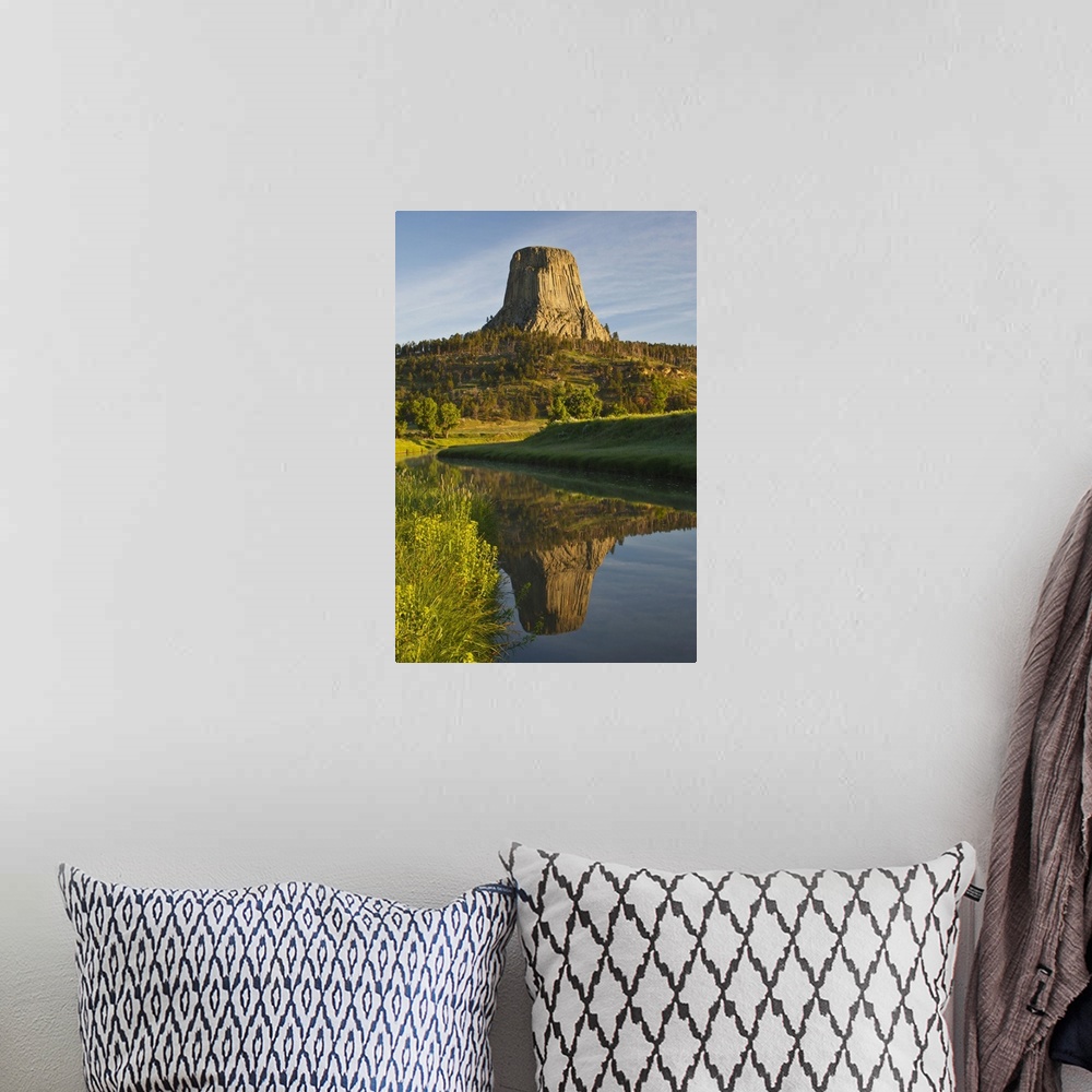 A bohemian room featuring Devil's Tower National Monument, Wyoming, reflected in Belle Fourche River at sunrise.