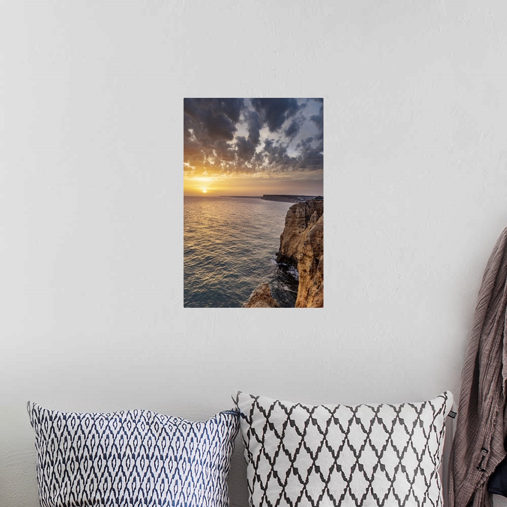 A bohemian room featuring Dramatic sunset clouds over Cliffs along the coast at Ponta da Piedade in Lagos, Portugal.