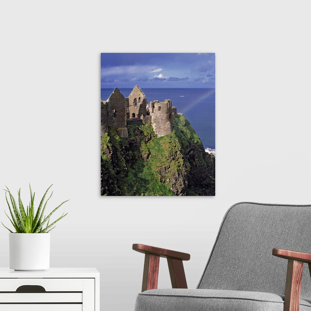A modern room featuring Dunluce Castle on the Antrim Coast in Co. Antrim in Northern Ireland has the pot at the end of th...