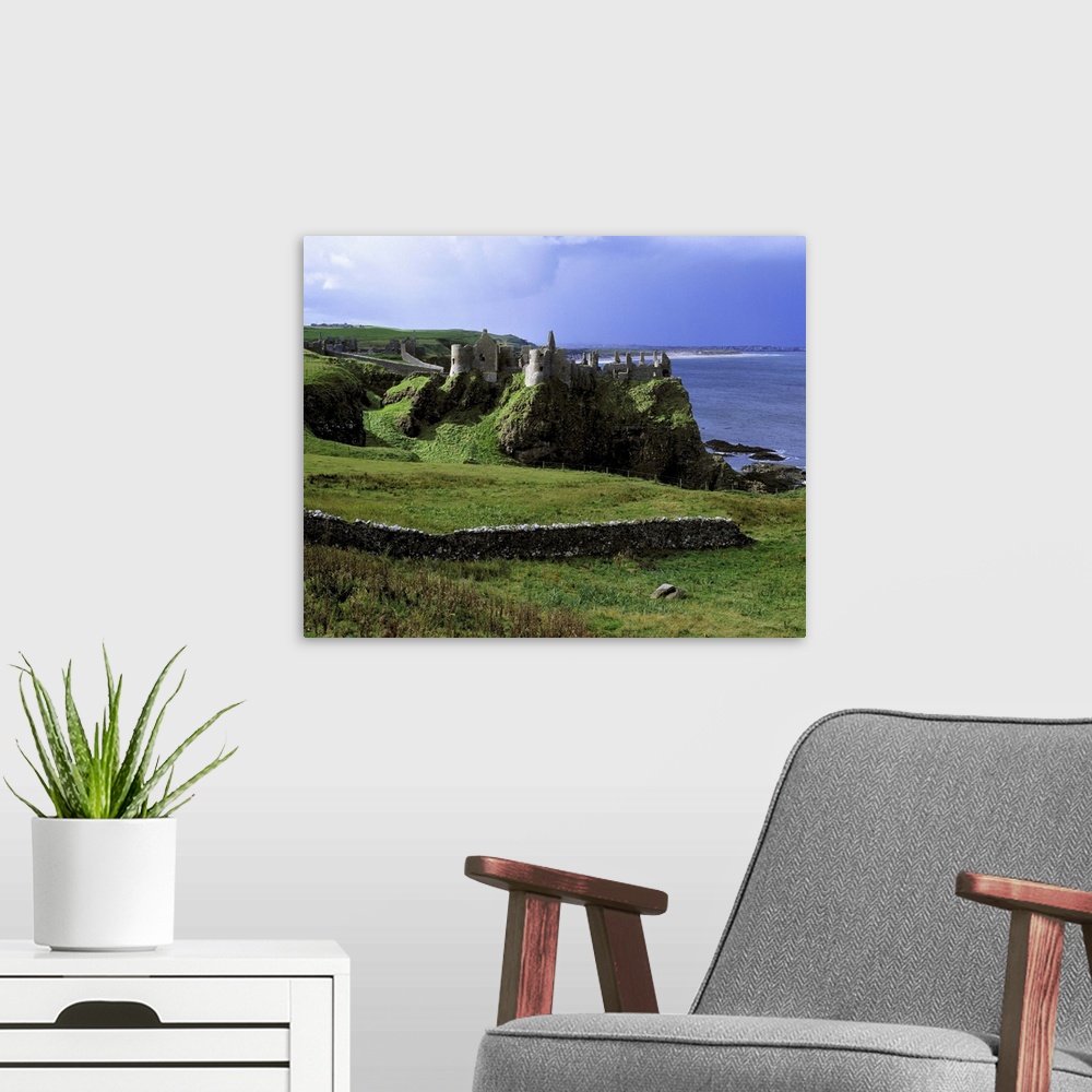 A modern room featuring Northern Ireland, County Antrim, Dunluce Castle. Dunluce Castle rises from the emerald hills on N...