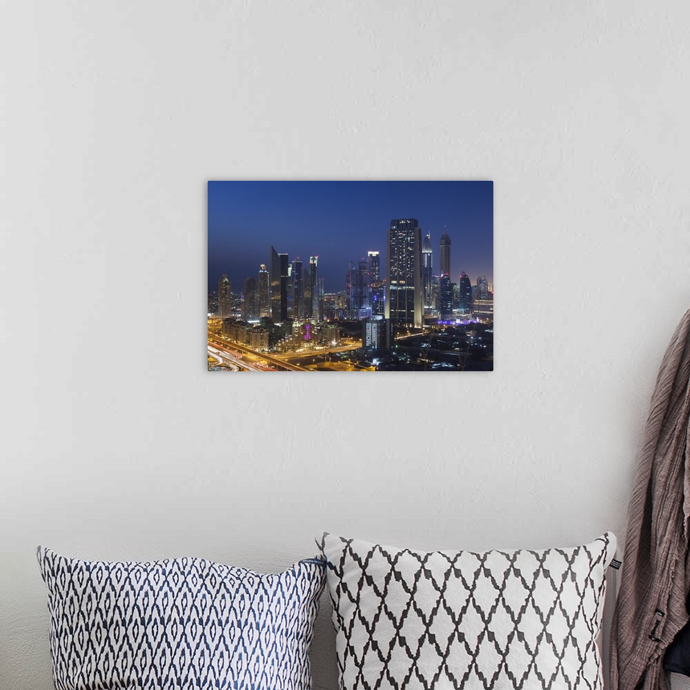 A bohemian room featuring UAE, Dubai, Downtown Dubai, elevated view of skyscrapers on Sheikh Zayed Road from downtown, dusk