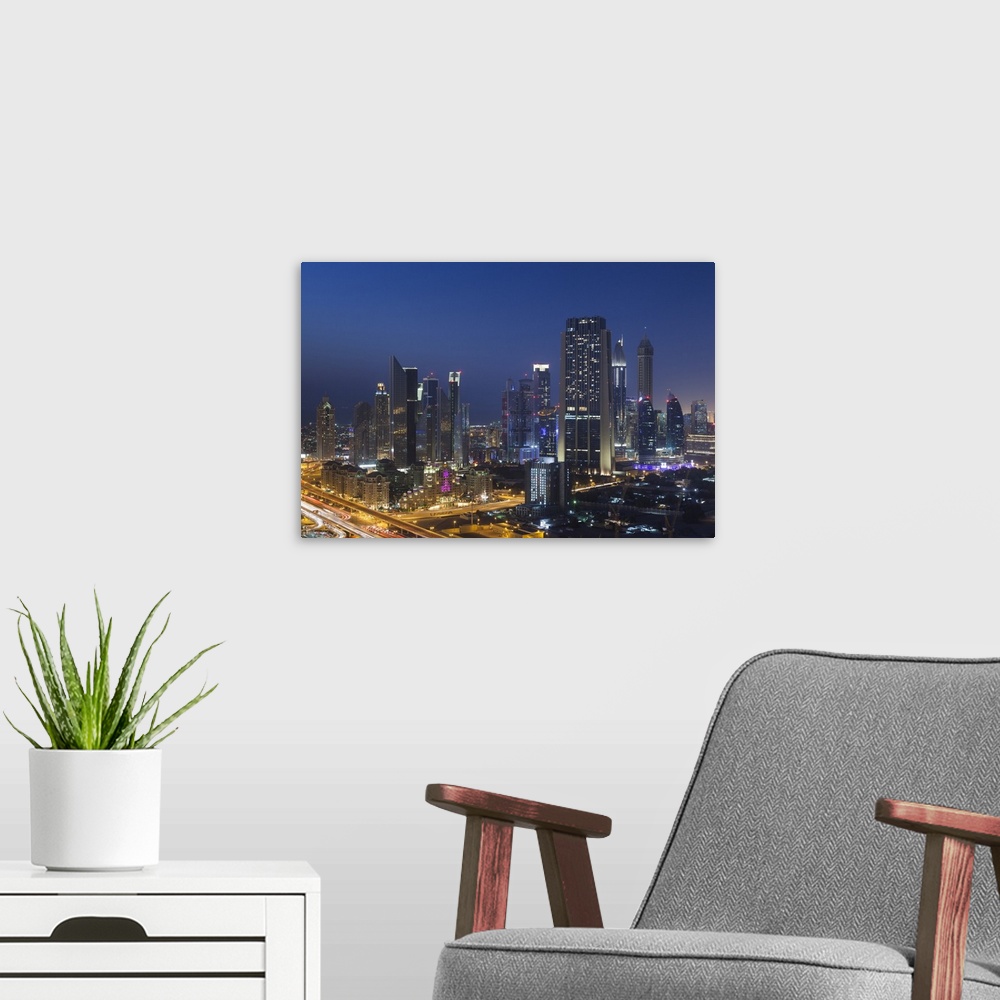A modern room featuring UAE, Dubai, Downtown Dubai, elevated view of skyscrapers on Sheikh Zayed Road from downtown, dusk