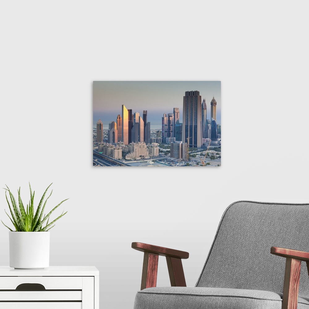 A modern room featuring UAE, Dubai, Downtown Dubai, elevated view of skyscrapers on Sheikh Zayed Road from downtown, dawn
