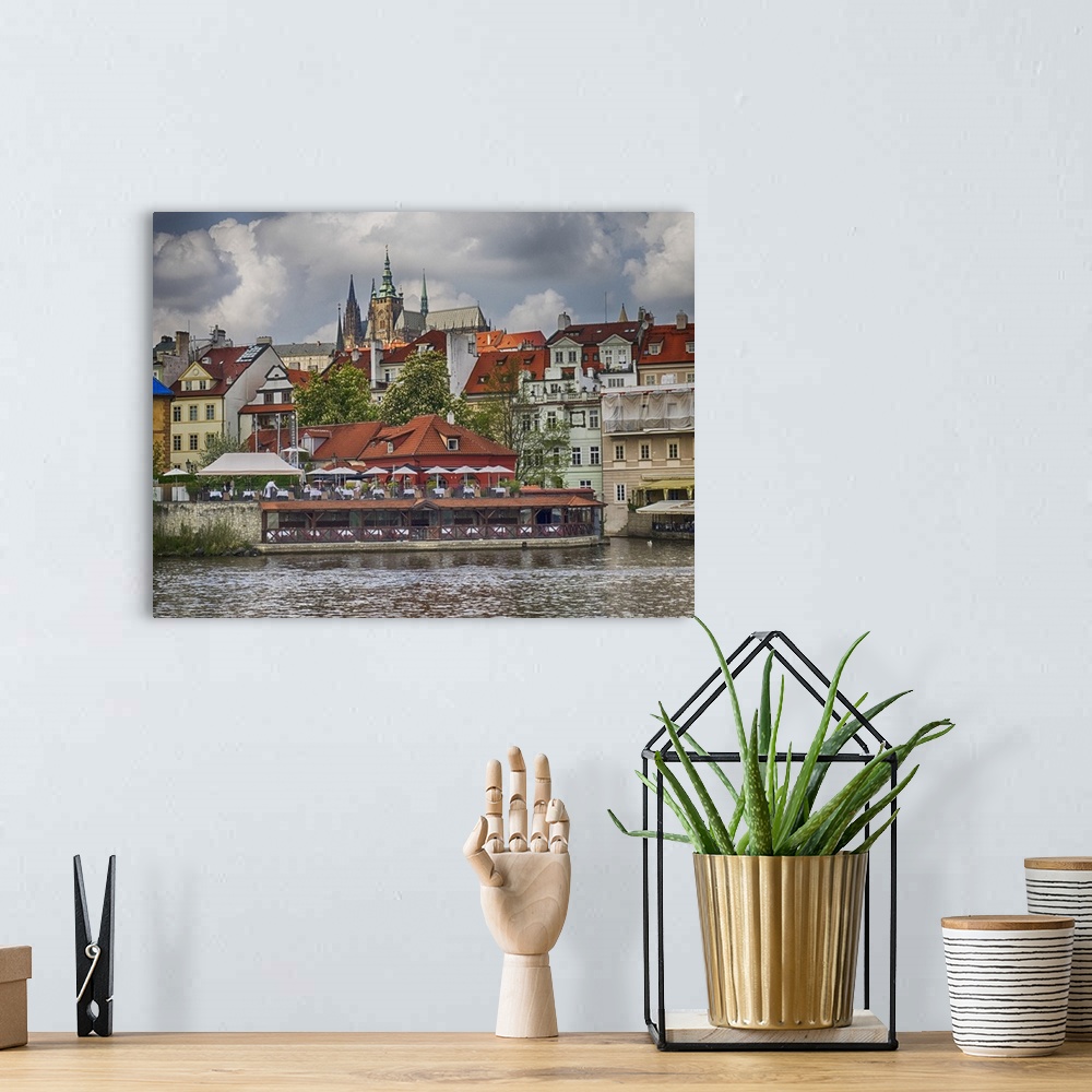 A bohemian room featuring Europe, Czech Republic, Prague. Restaurant along the Vltava River from a riverboat.