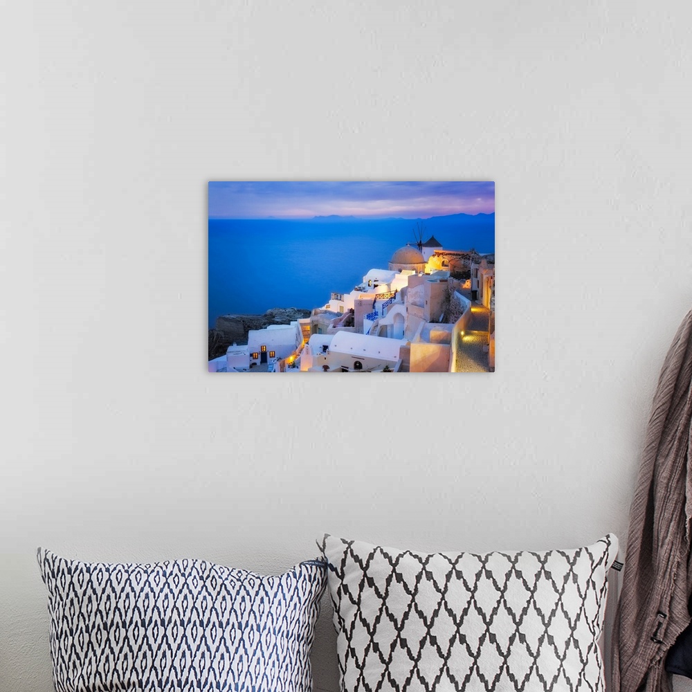A bohemian room featuring Europe, Greece, Santorini, Oia. Sunset on coastal town. Credit: Jim Nilsen
