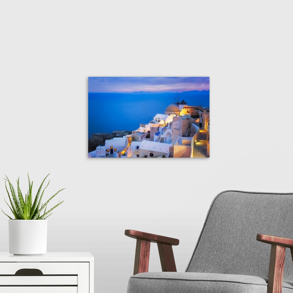 A modern room featuring Europe, Greece, Santorini, Oia. Sunset on coastal town. Credit: Jim Nilsen