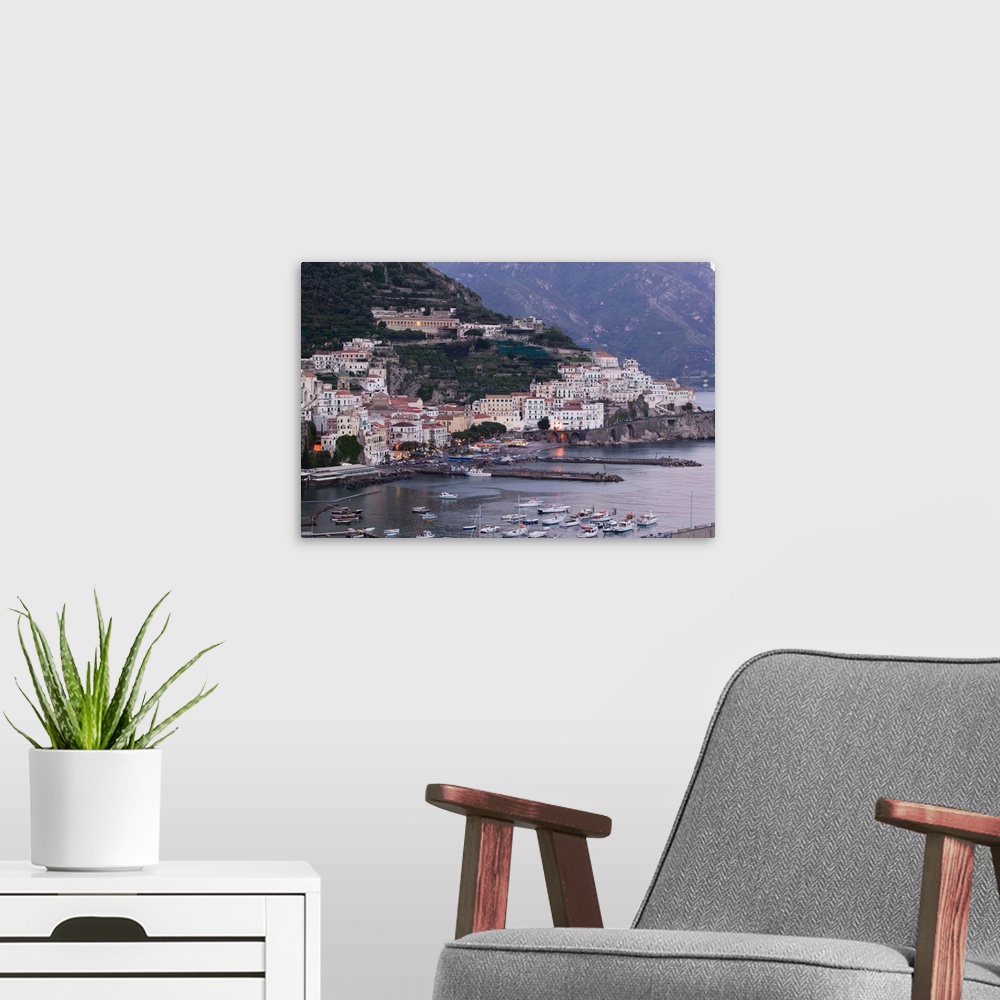 A modern room featuring ITALY-Campania-(Amalfi Coast)-AMALFI:.Town View with Harbor / Evening... Walter Bibikow 2005