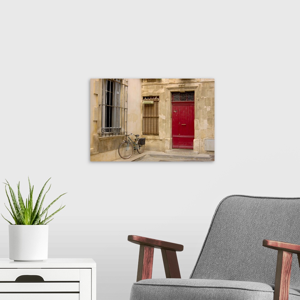 A modern room featuring France, Arles, Provence, bicycle parked along building