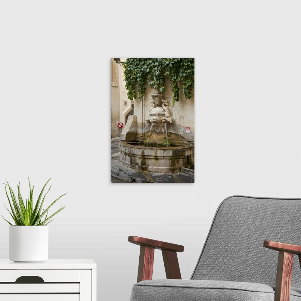 A modern room featuring France, Provence, St. Remy-de-Provence. Water fountain on street corner. Credit as: Fred Lord / J...