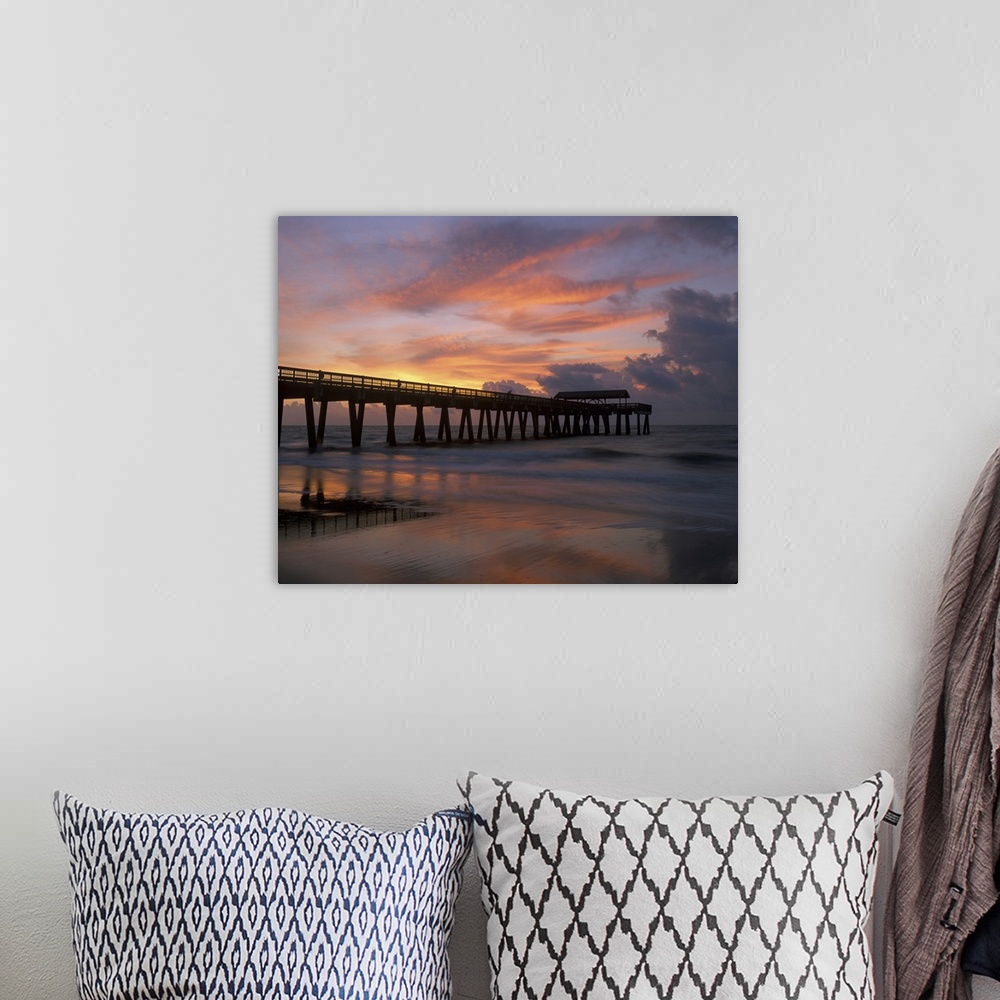 A bohemian room featuring Georgia Tybee Island, pier at sunrise with reflections of clouds on beach.