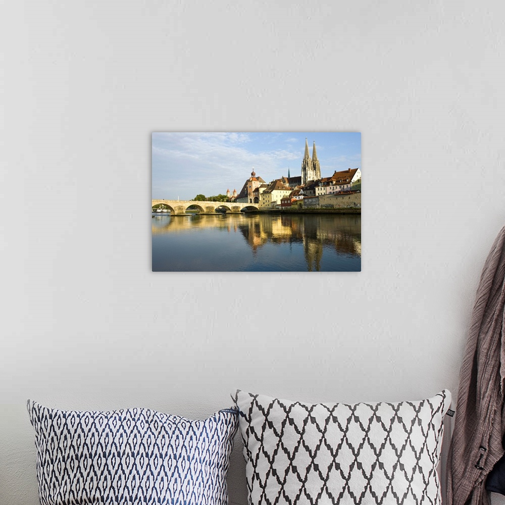 A bohemian room featuring Germany, Bayern-Bavaria, Regensburg. View from Danube River and Steinerne Bridge.