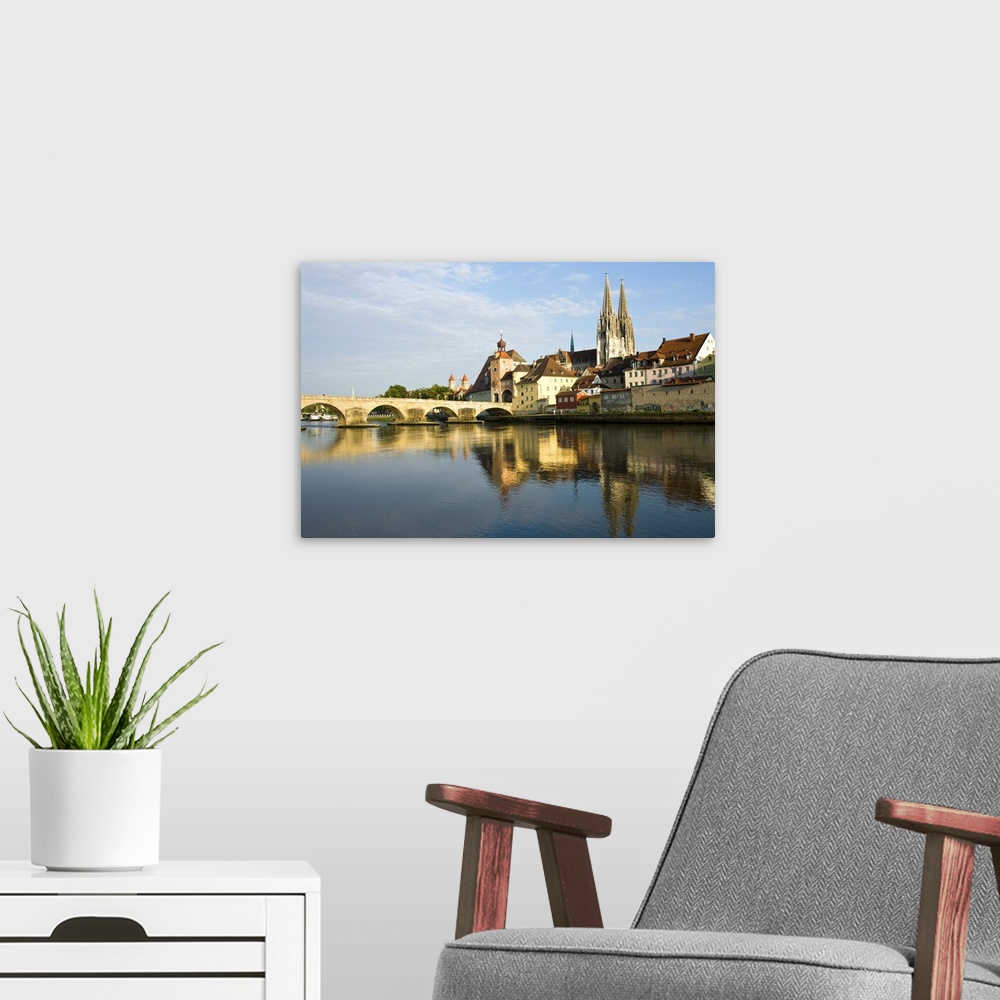 A modern room featuring Germany, Bayern-Bavaria, Regensburg. View from Danube River and Steinerne Bridge.