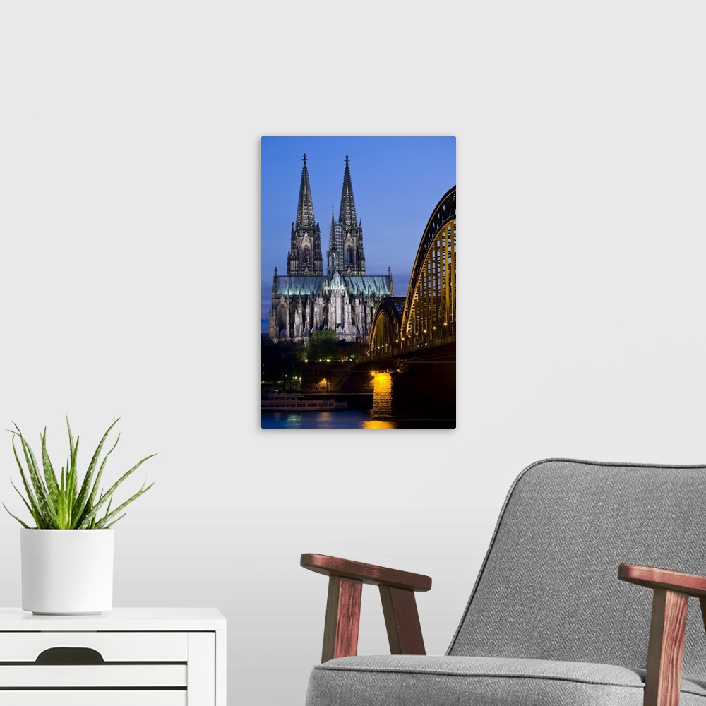 A modern room featuring Germany, Nordrhein-Westfalen, Cologne. Cologne Cathedral and Hohenzollern Bridge, evening.