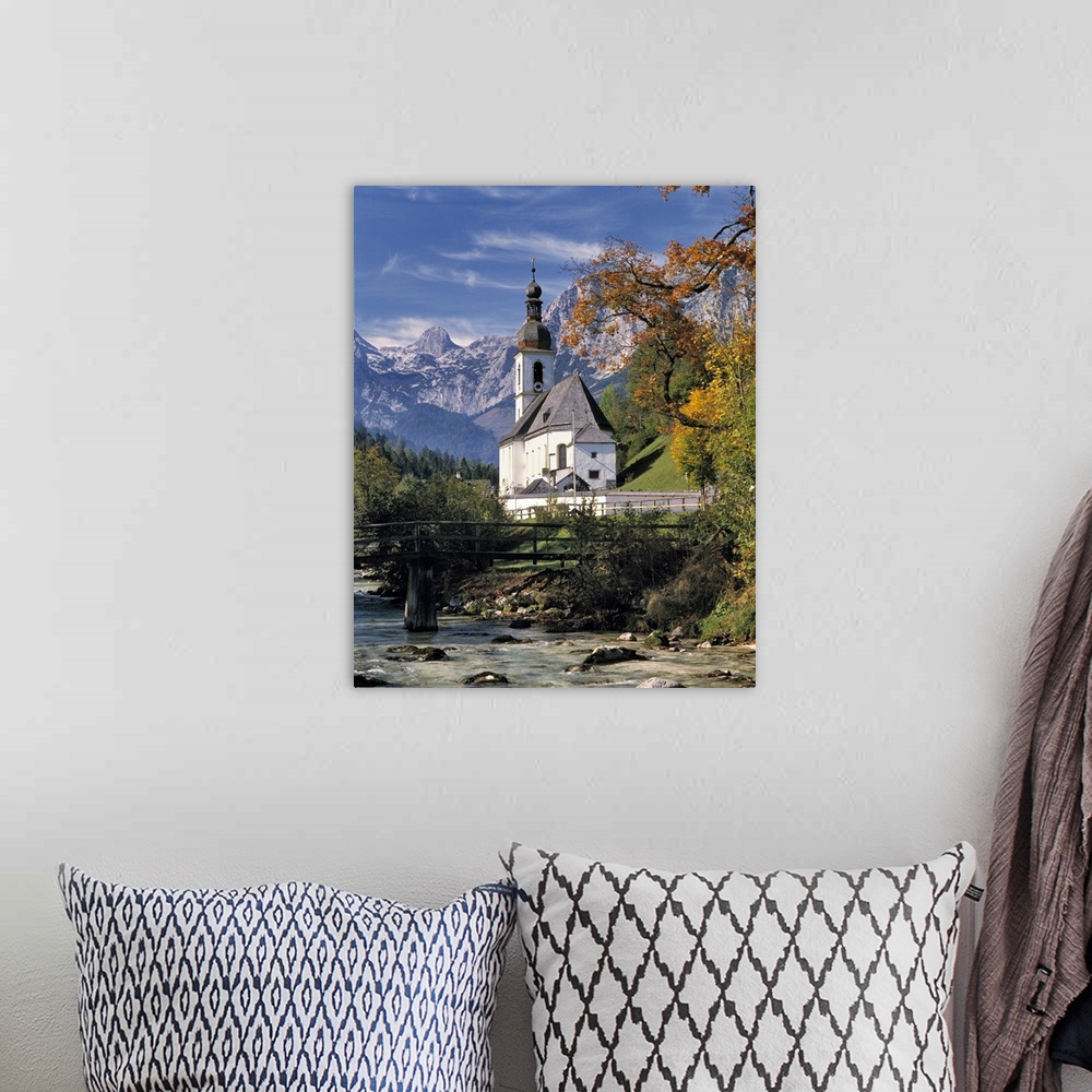 A bohemian room featuring Germany, Bavaria, Ramsau. The Ramsauer Ache flows by the church, or Kunterwegkirche, at Ramsau in...