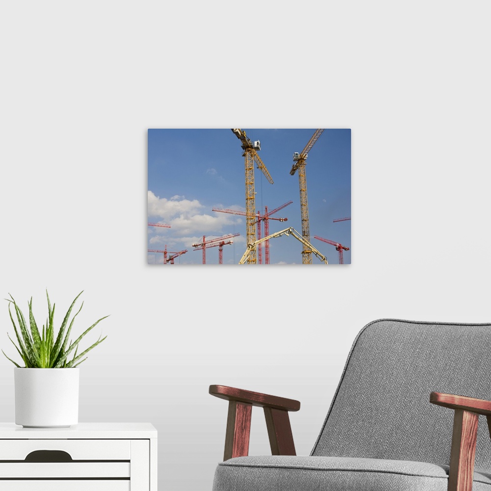 A modern room featuring Germany, State of Hamburg, Hamburg. Construction cranes, HafenCity.