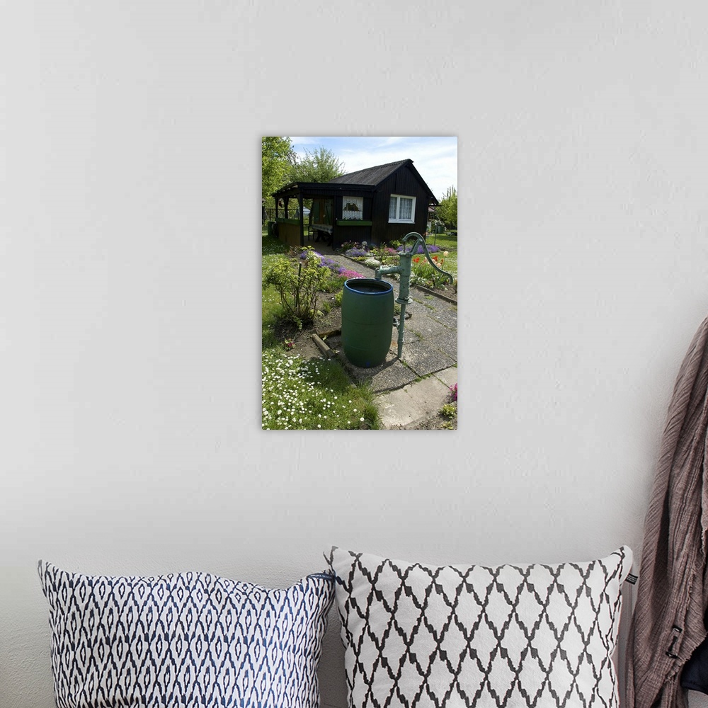 A bohemian room featuring Germany, Straubing, water barrel and pump in cottage garden in Spring