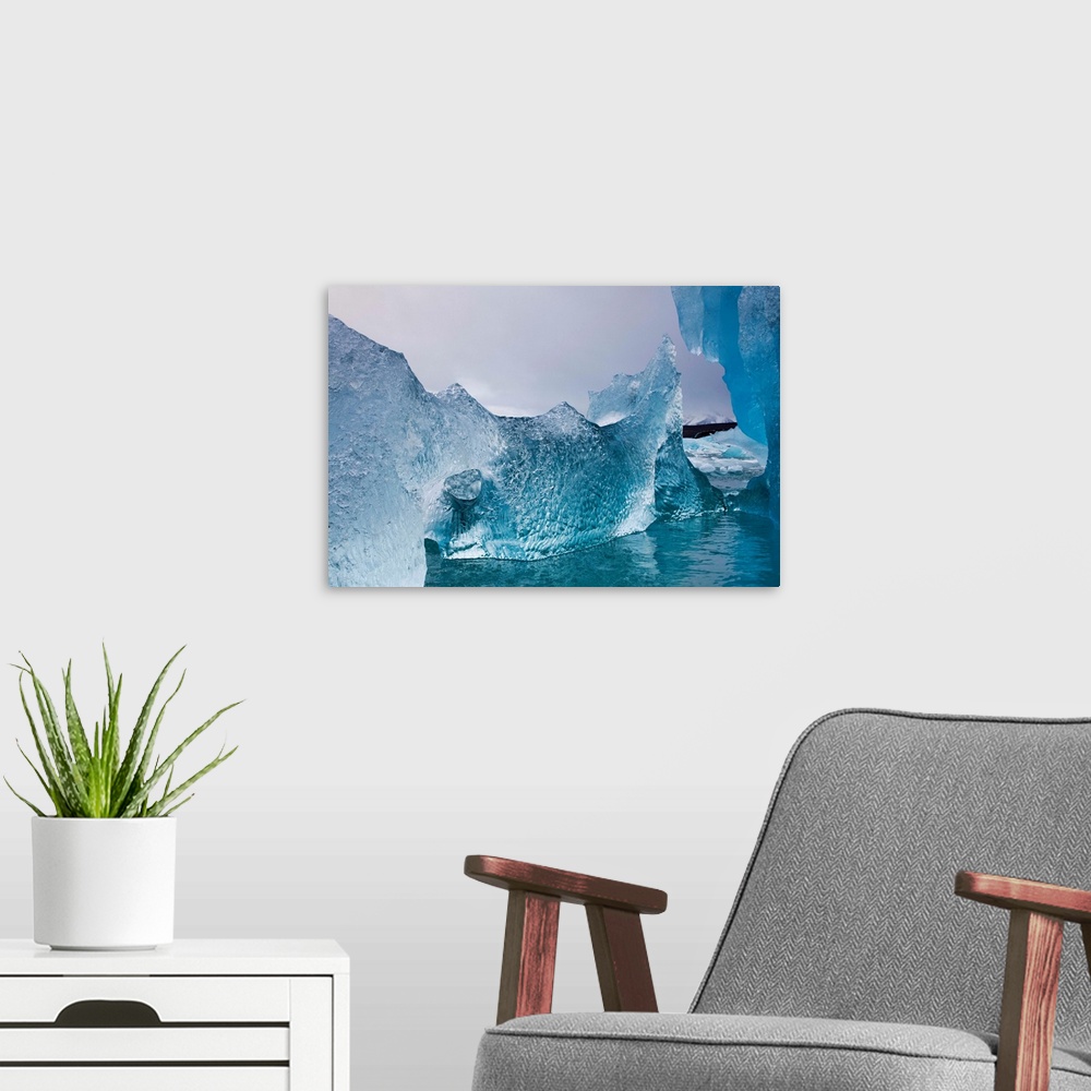 A modern room featuring Norway, Svalbard, Spitsbergen Island, Deep blue icebergs floating near face of Sveabreen Glacier ...