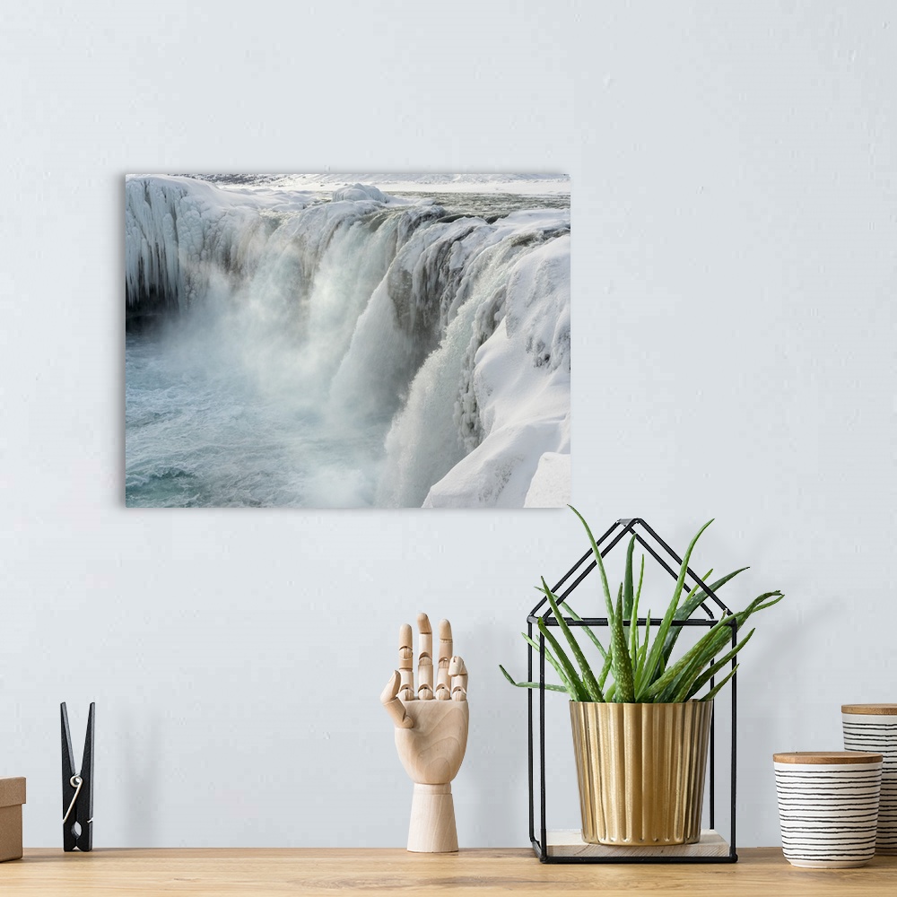 A bohemian room featuring Godafoss waterfall of Iceland during winter. .
