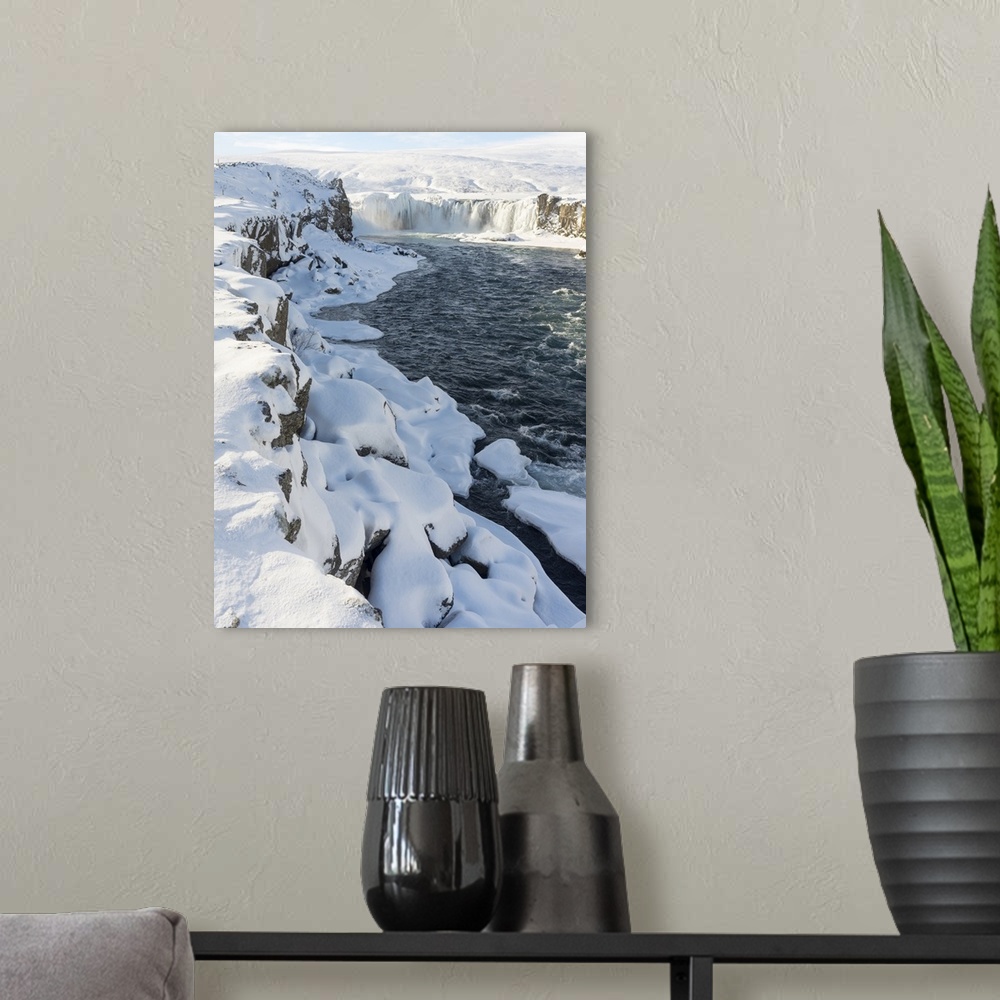 A modern room featuring Godafoss waterfall of Iceland during winter..