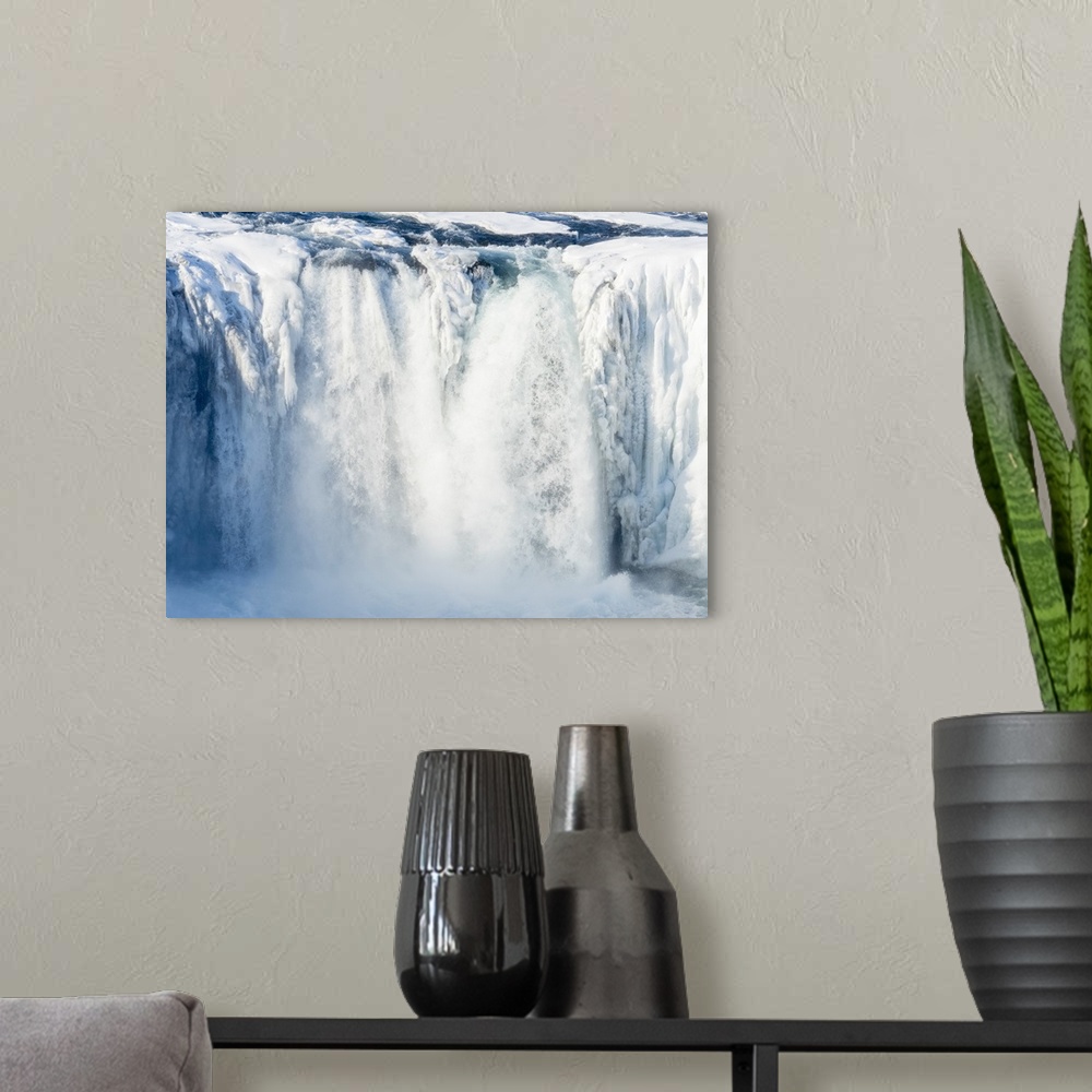 A modern room featuring Godafoss waterfall of Iceland during winter..