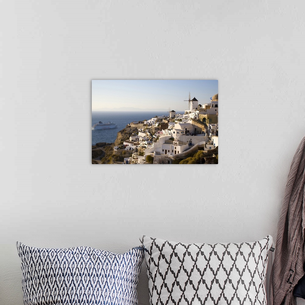 A bohemian room featuring Greece and Greek Island of Santorini town of Oia in evening light with the many homes and busines...