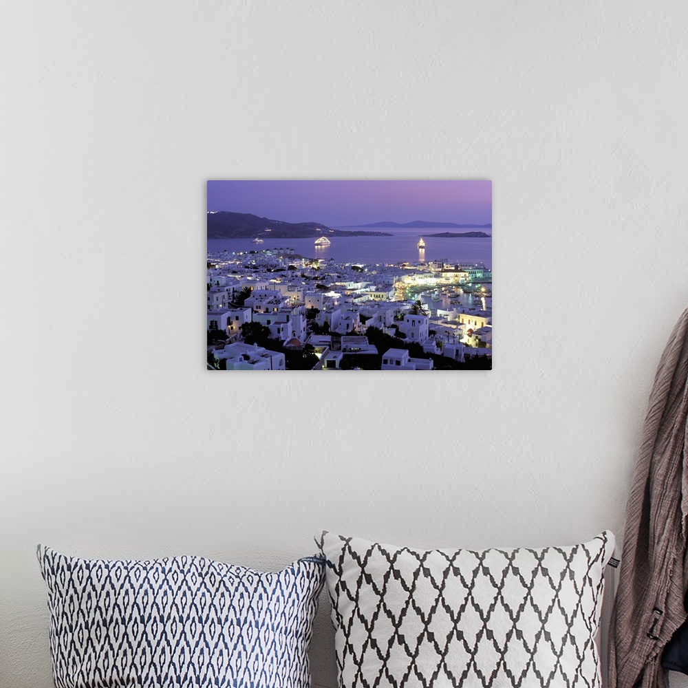 A bohemian room featuring Europe, Greece, Cyclades Islands, Mykonos. Evening view of Mykonos town from hillside fort