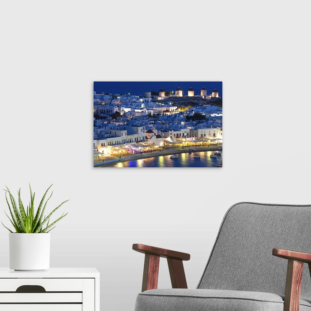 A modern room featuring Europe, Greece, Mykonos, Hora. Night view overlooking harbor with illuminated windmills atop hill...