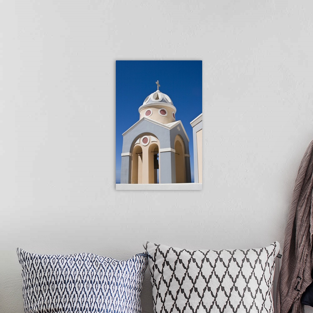 A bohemian room featuring Europe, Greece, Santorini. Peach and grey church bell tower against clear blue sky.